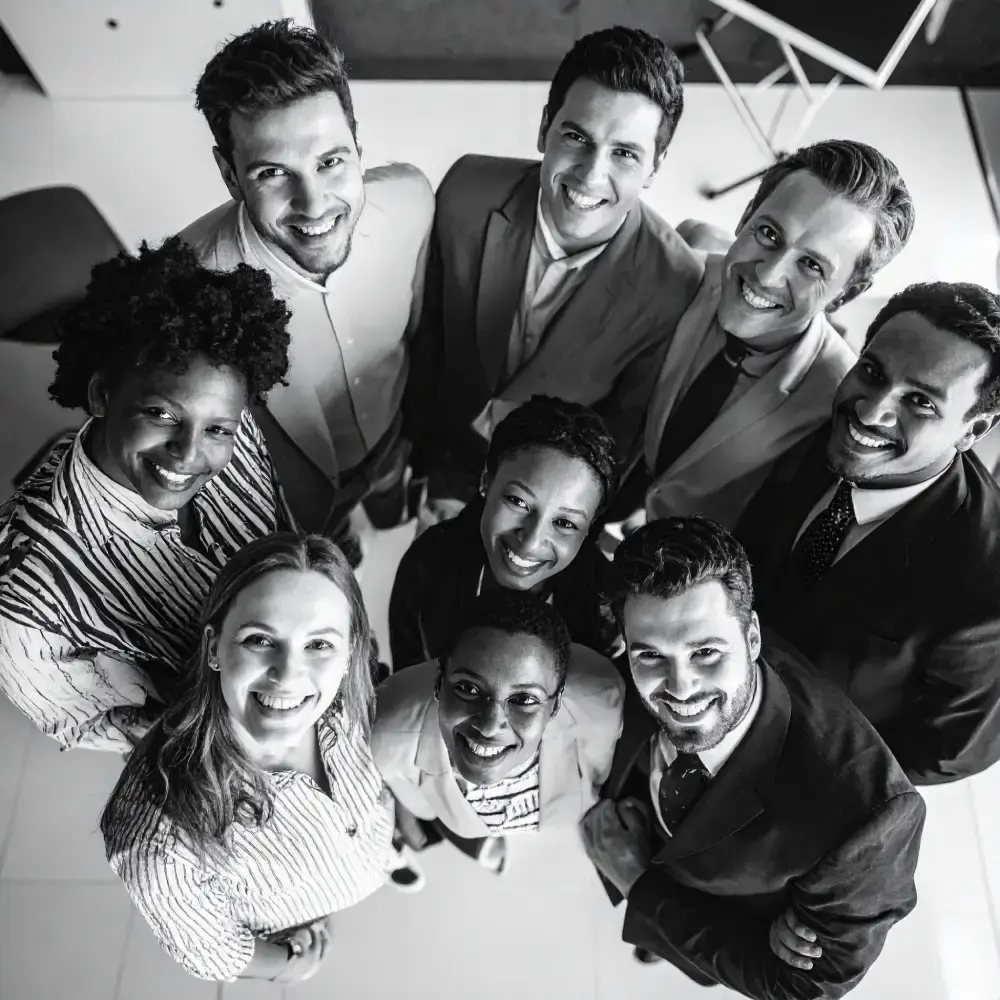Smiling faces of a team meeting black and white